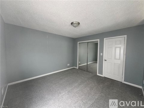 A room with grey walls and a white door.