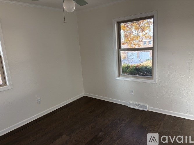 A room with a window and a ceiling fan.