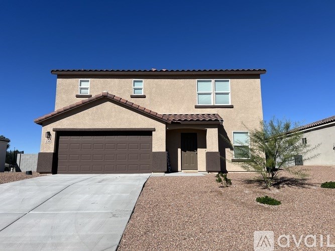 A house with a brown garage door and a brown tiled roof.