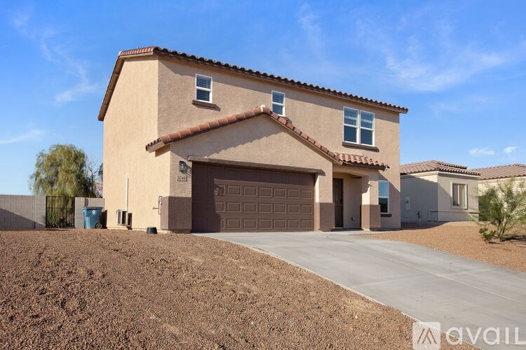 A house with a brown stucco exterior and a tiled roof is available for sale.