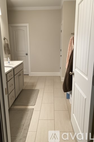 A bathroom with a towel hanging on the door.