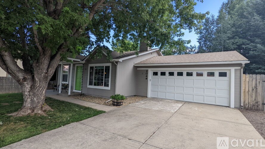 A house with a tree in front of it.