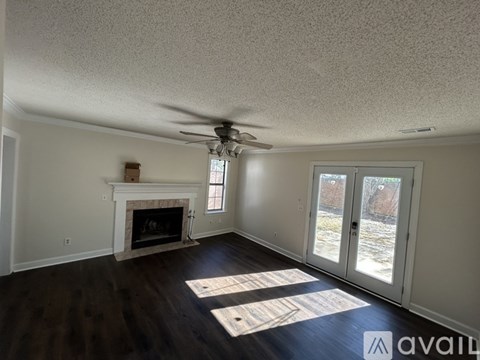 A living room with a fireplace and sliding glass doors.