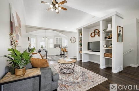 A living room with a grey couch and a wooden coffee table.