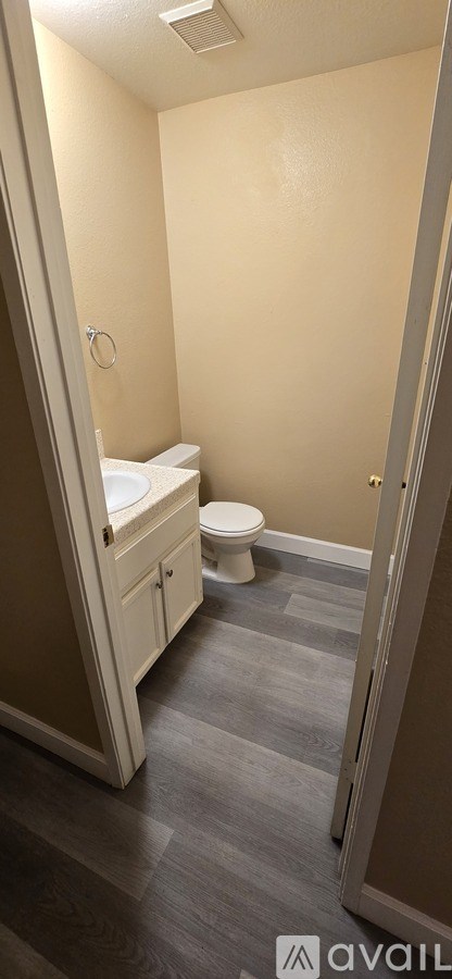 A bathroom with a toilet and a sink.