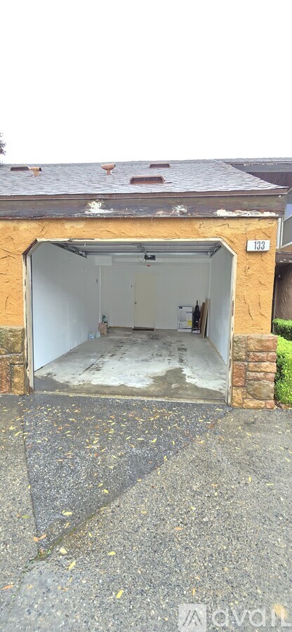 A garage with a brick wall and a white door.