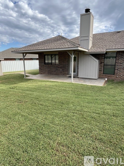 A house with a white fence and a chimney.