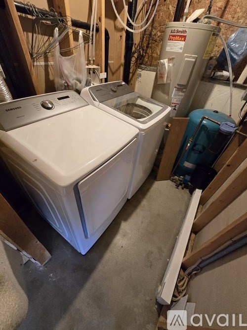 A white dryer is on the left and a blue washing machine is on the right.