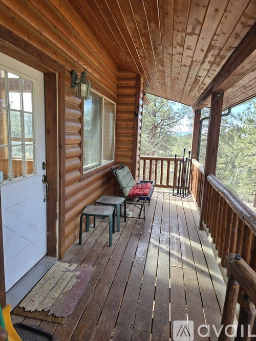 A wooden deck with a table and chairs.