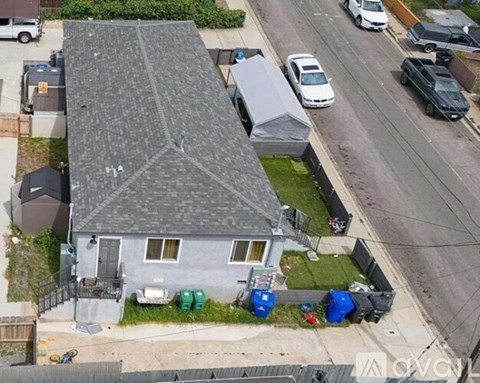 A grey house with a grey roof and a grey garage door.