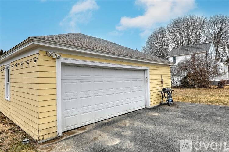 A yellow house with a white garage door.