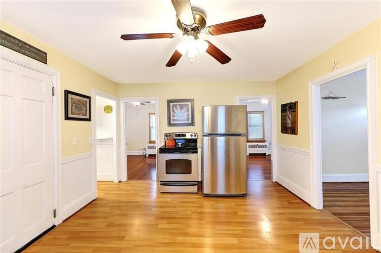 A kitchen with a stainless steel refrigerator and a ceiling fan.