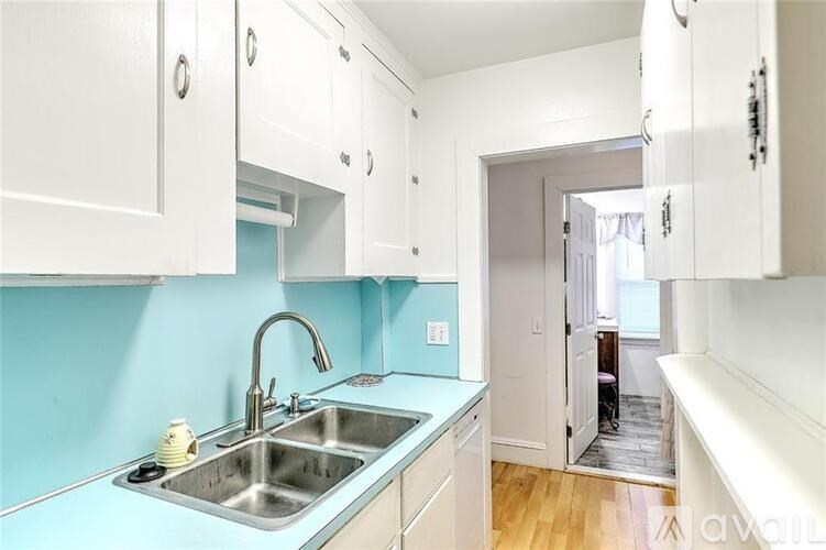 A kitchen with a sink and cabinets.