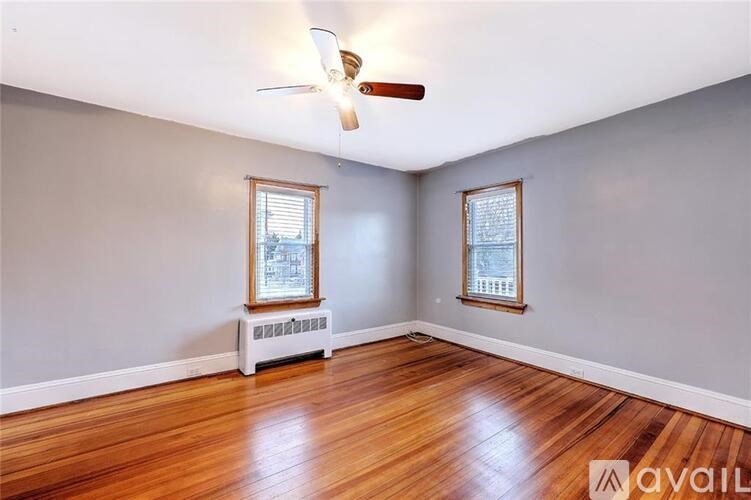 A room with wooden floors and a ceiling fan.