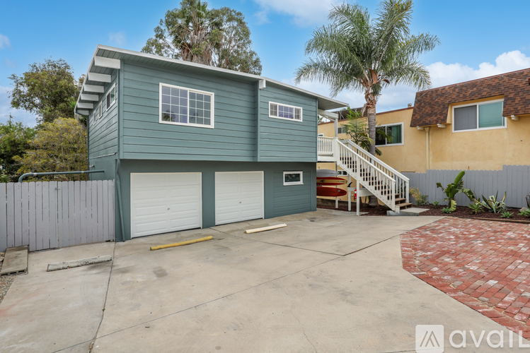 A two-story house with a garage is available for rent.
