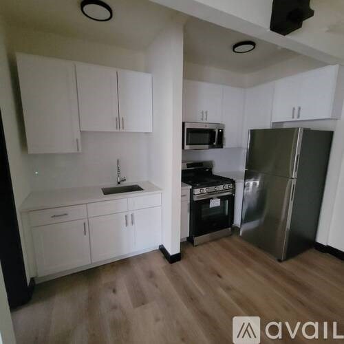 A kitchen with white cabinets and stainless steel appliances.