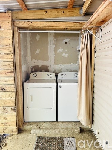 A small laundry room with a washer and dryer.