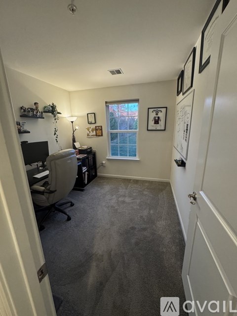 A room with a desk and a window.