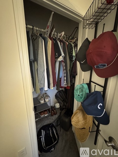 A closet full of hats and clothes.