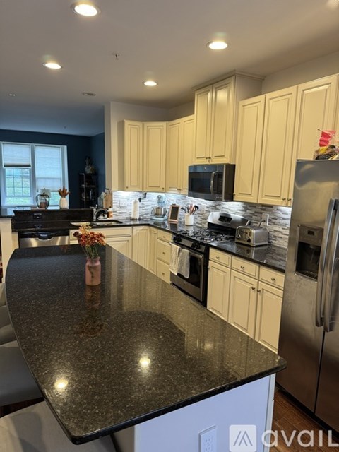 A kitchen with granite countertops and stainless steel appliances.