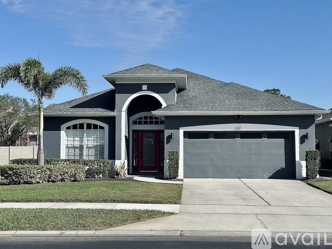 A house with a red door and a grey roof.