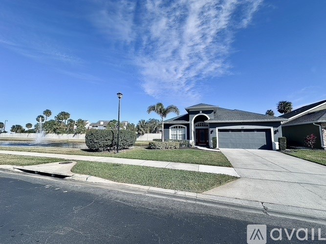 A house with a driveway and a street lamp in front of it.