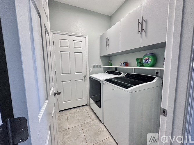 A kitchen with a white door and a white dishwasher.