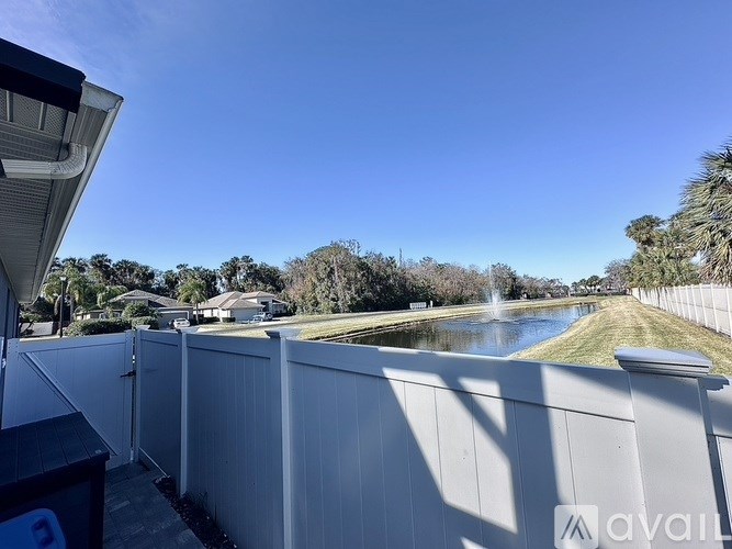 A view from a balcony overlooking a river and houses.