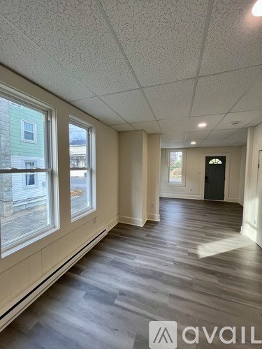 A room with a wooden floor and a white ceiling.