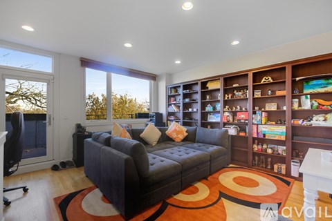 A living room with a grey couch and a white coffee table.