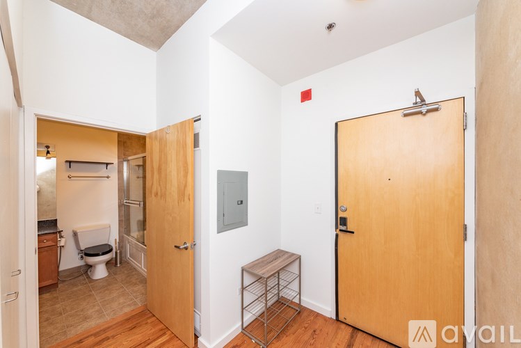A bathroom with a toilet, sink, and shower area.