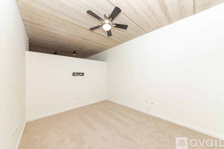 A room with a ceiling fan and a light fixture.