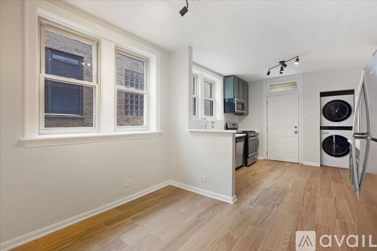 A kitchen with a refrigerator, microwave, and oven.