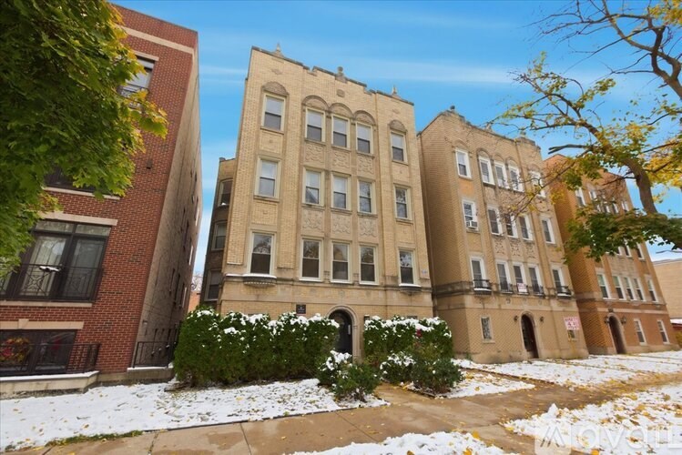 A building with a red brick wall and a white window.