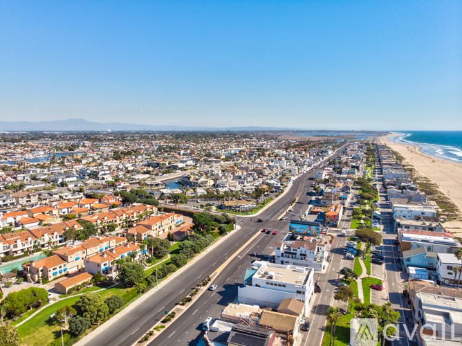 A coastal city with a beach and a highway running through it.