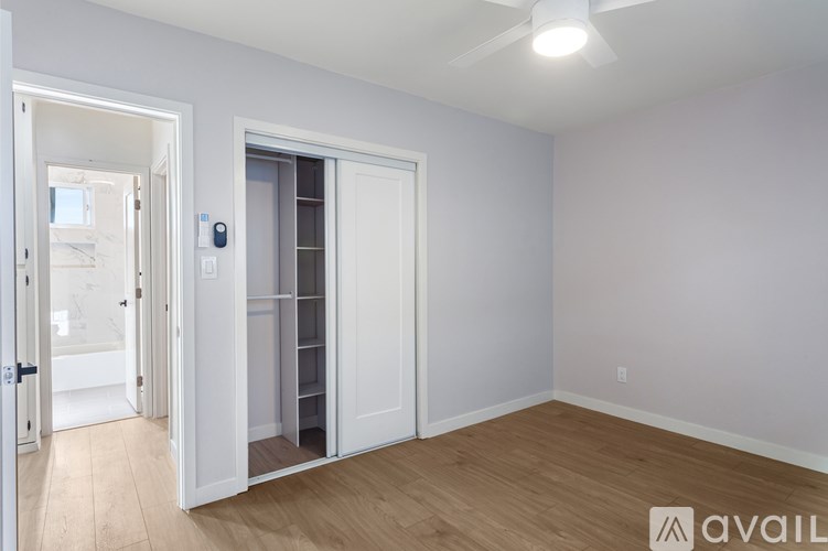 A room with a white door and a white wall.