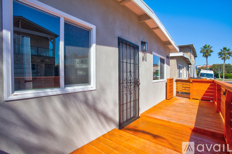 A row of houses with a wooden deck in the foreground.