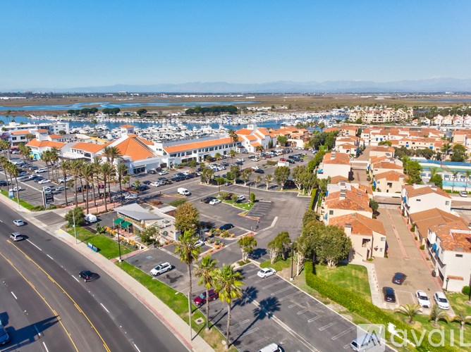 A sunny day in a small town with a view of the ocean.