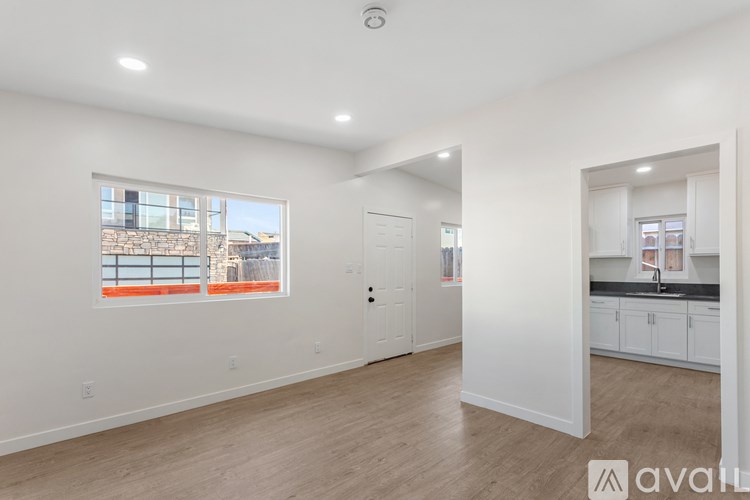 A spacious, empty room with a window overlooking a building.