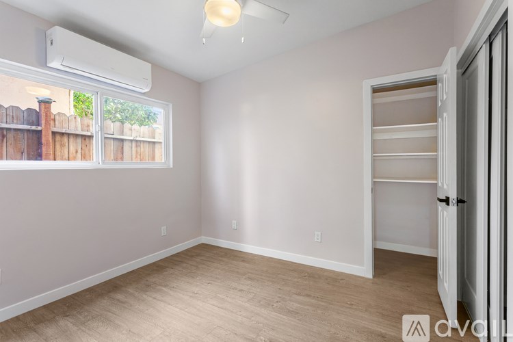 A room with a sliding door and a window.