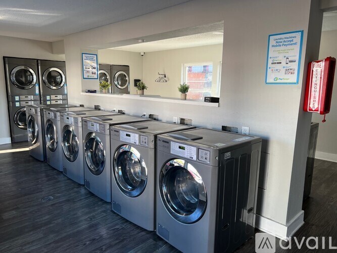 A row of washing machines in a laundromat.
