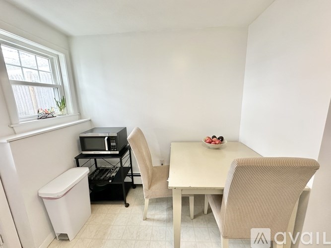 A small kitchen with a table and chairs.