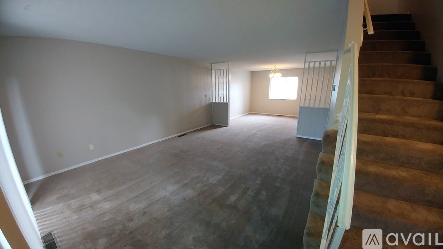 A room with a staircase leading to the upper floor.