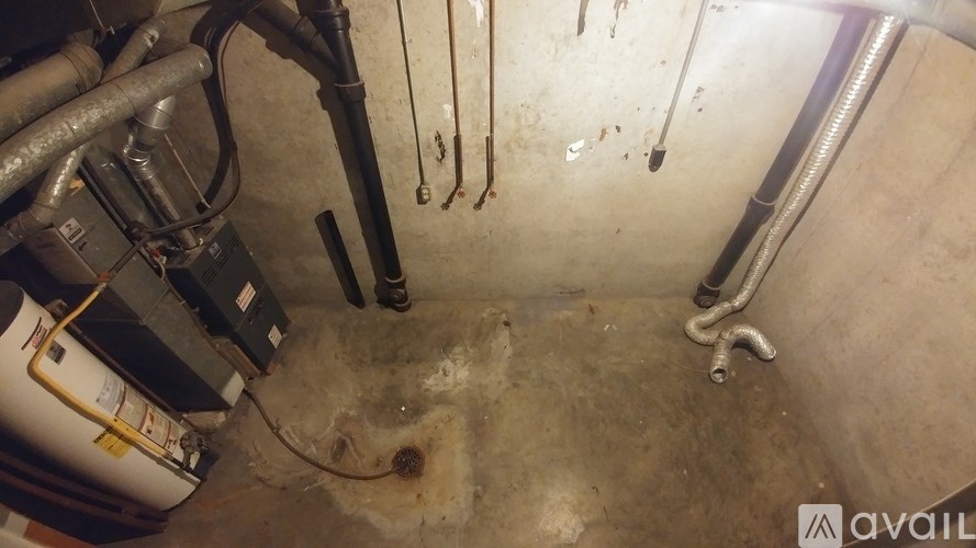 A dirty, cluttered workshop with various tools and equipment.