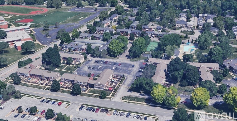 A parking lot is in the foreground of this aerial view of a neighborhood.
