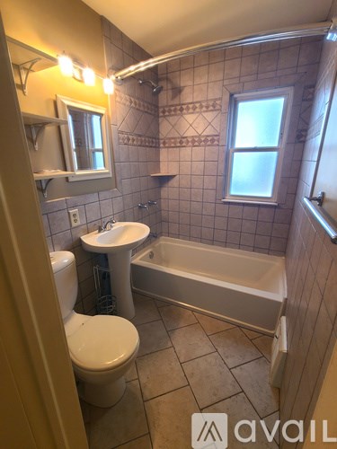 A bathroom with a toilet, sink, and bathtub.
