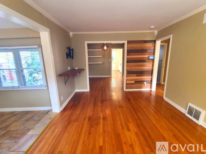 A room with wooden floors and a sliding door.