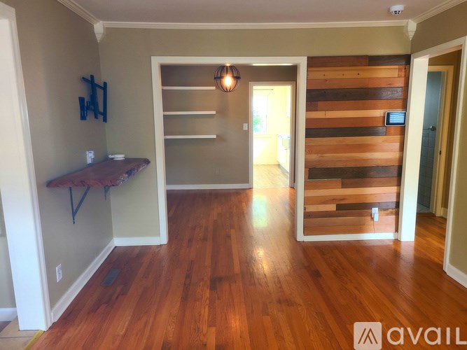 A room with wooden floors and a wooden wall panel.