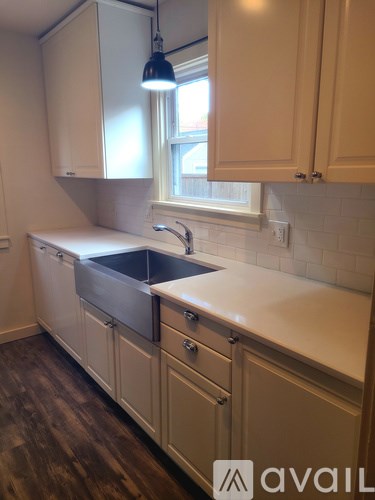 A kitchen with wooden cabinets and a white sink.