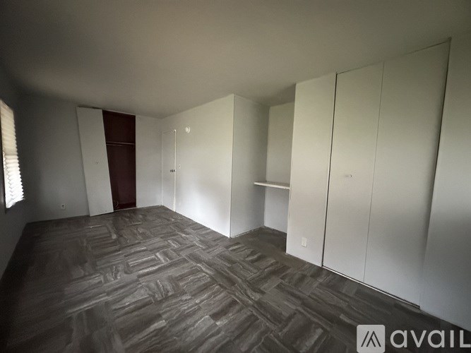 A room with a carpeted floor and white walls.